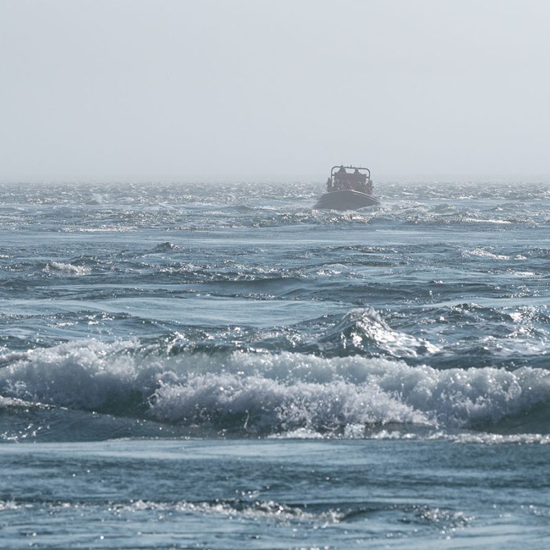 The swelling waters of the Corryvreckan Whirlpool with a boat in the background